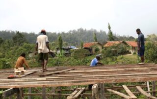 Young people build houses in Oksibil.